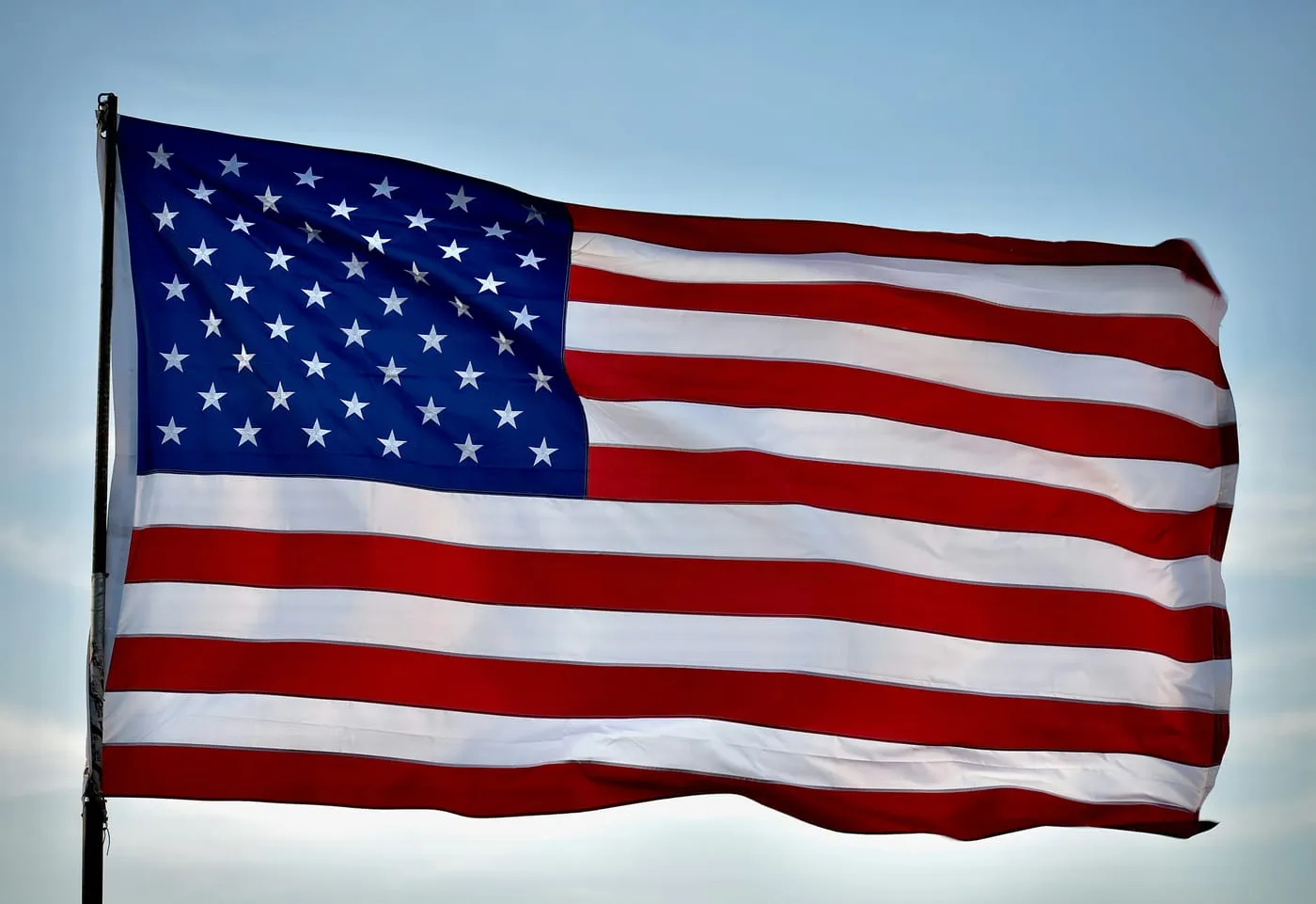 An American Flag waving against the sky